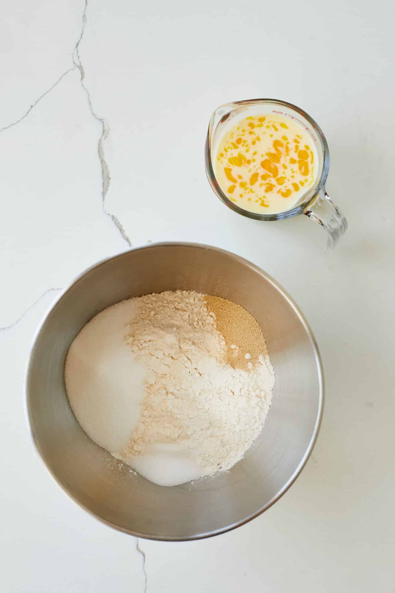 Brioche Burger Buns1 Flour, sugar, yeast, and salt in the bowl of a stand mixer, eggs and milk in a jug.