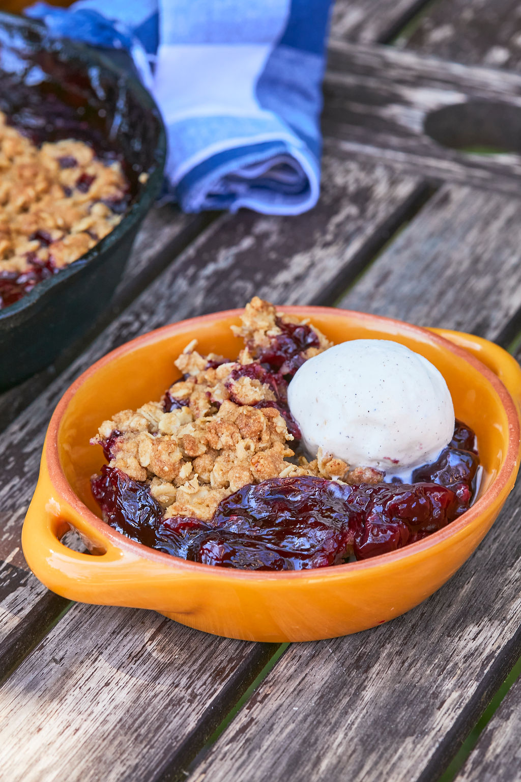 A serving of my Skillet Cherry Crisp recipe with vanilla ice cream on top.