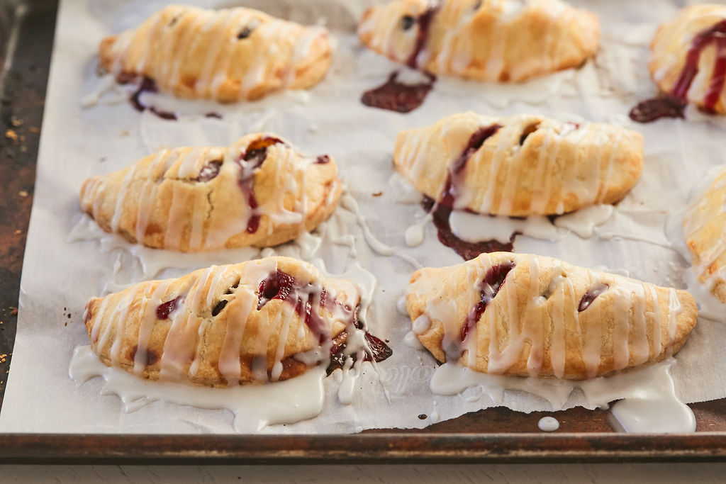 Cherry Hand Pies recipe, completed, on a baking sheet.