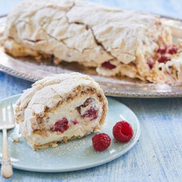 Hazelnut and Raspberry Roulade served on a dish.