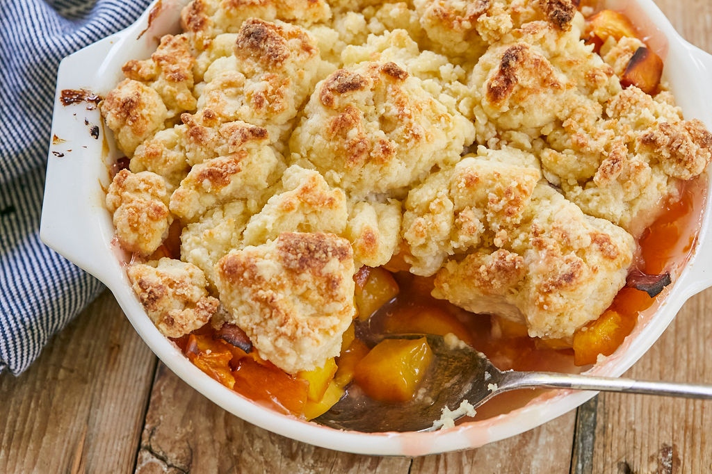 A top-down view of my Best-Ever Peach Cobbler recipe to show texture, color, and peaches.