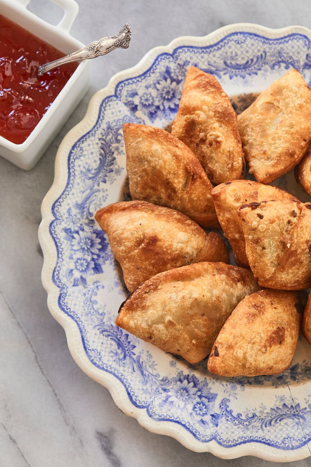 A plate of finished samosas ready to eat. Finished and baked authentic samosas ready for dipping and eating.