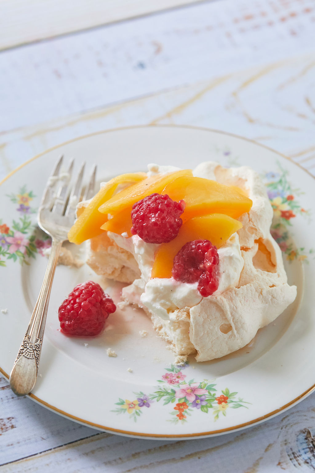 A close up of my meringues recipe, showing texture and my peach and raspberry compote.