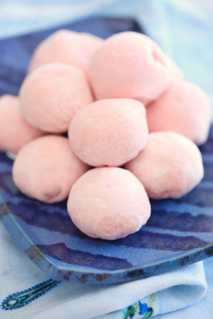 A mound of Japanese Mochi Ice Cream with pink, soft mochi.