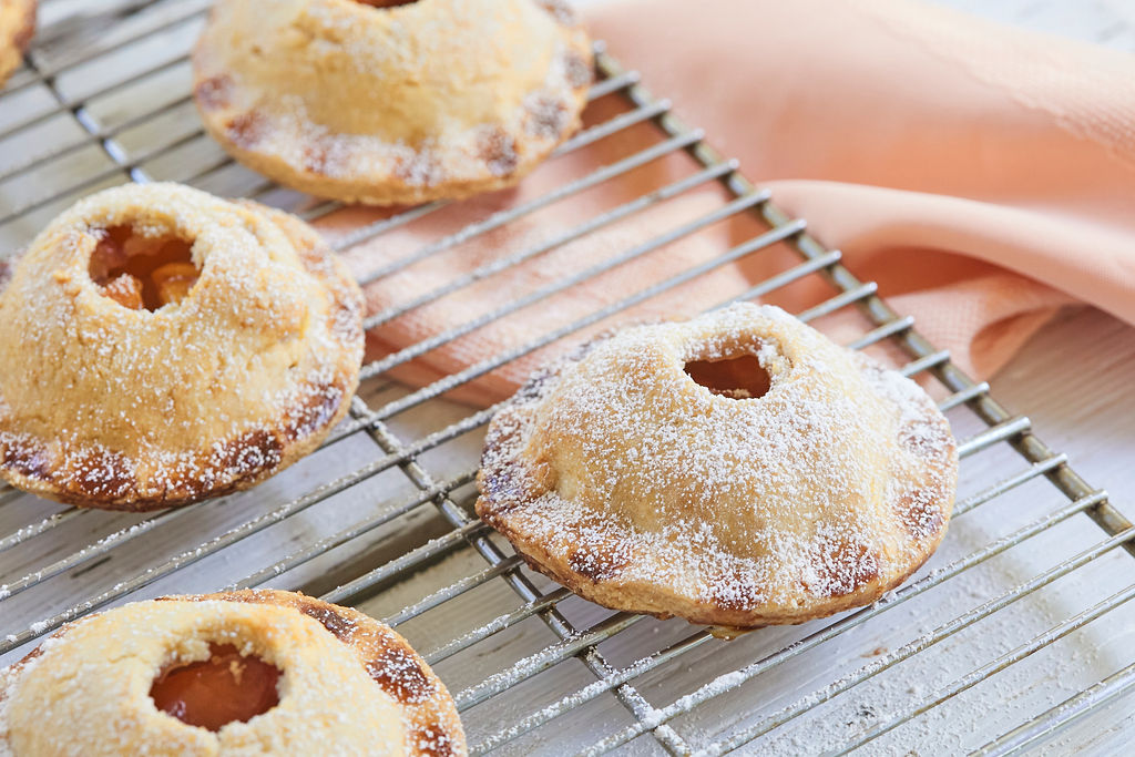 Peach Hand Pies lightly dusted with icing sugar.