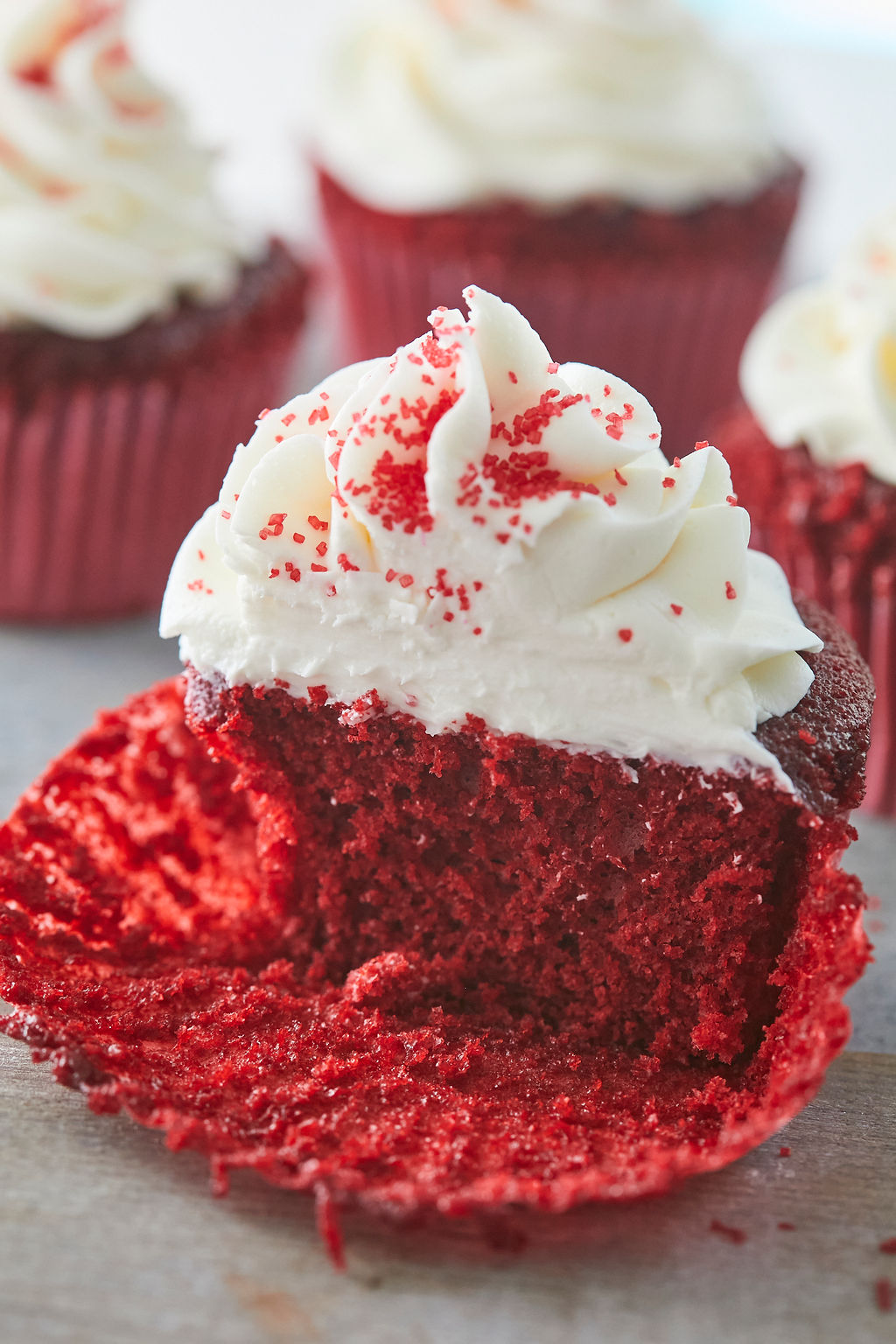 A cross-section of my red velvet cupcake recipe and cream cheese frosting to show texture and consistency.