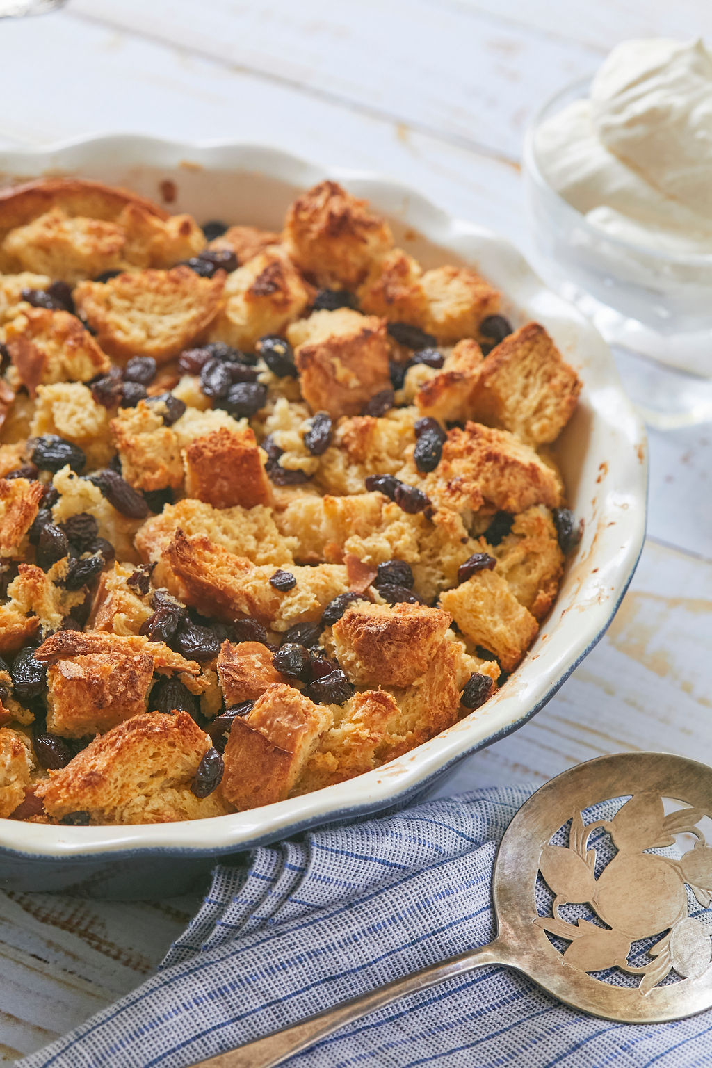 Rum Raisin Bread and Butter Pudding in a bowl with loads of rum-soaked raisins.