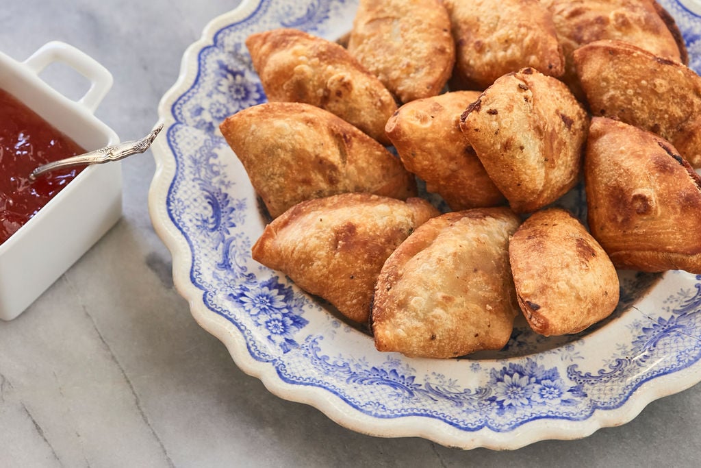 A plate of golden-baked homemade authentic samosas.