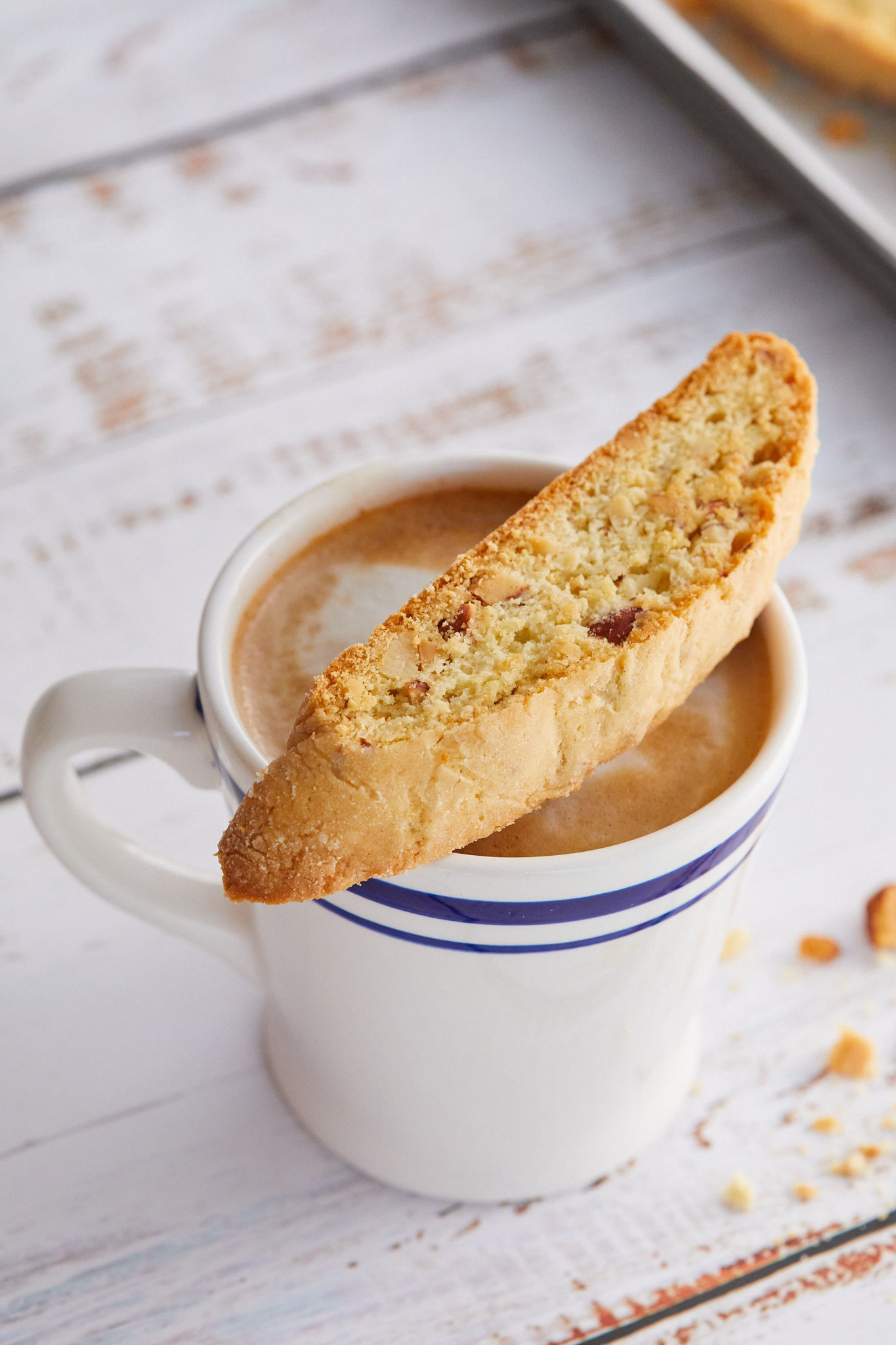My almond biscotti sitting on top of a cup of coffee.