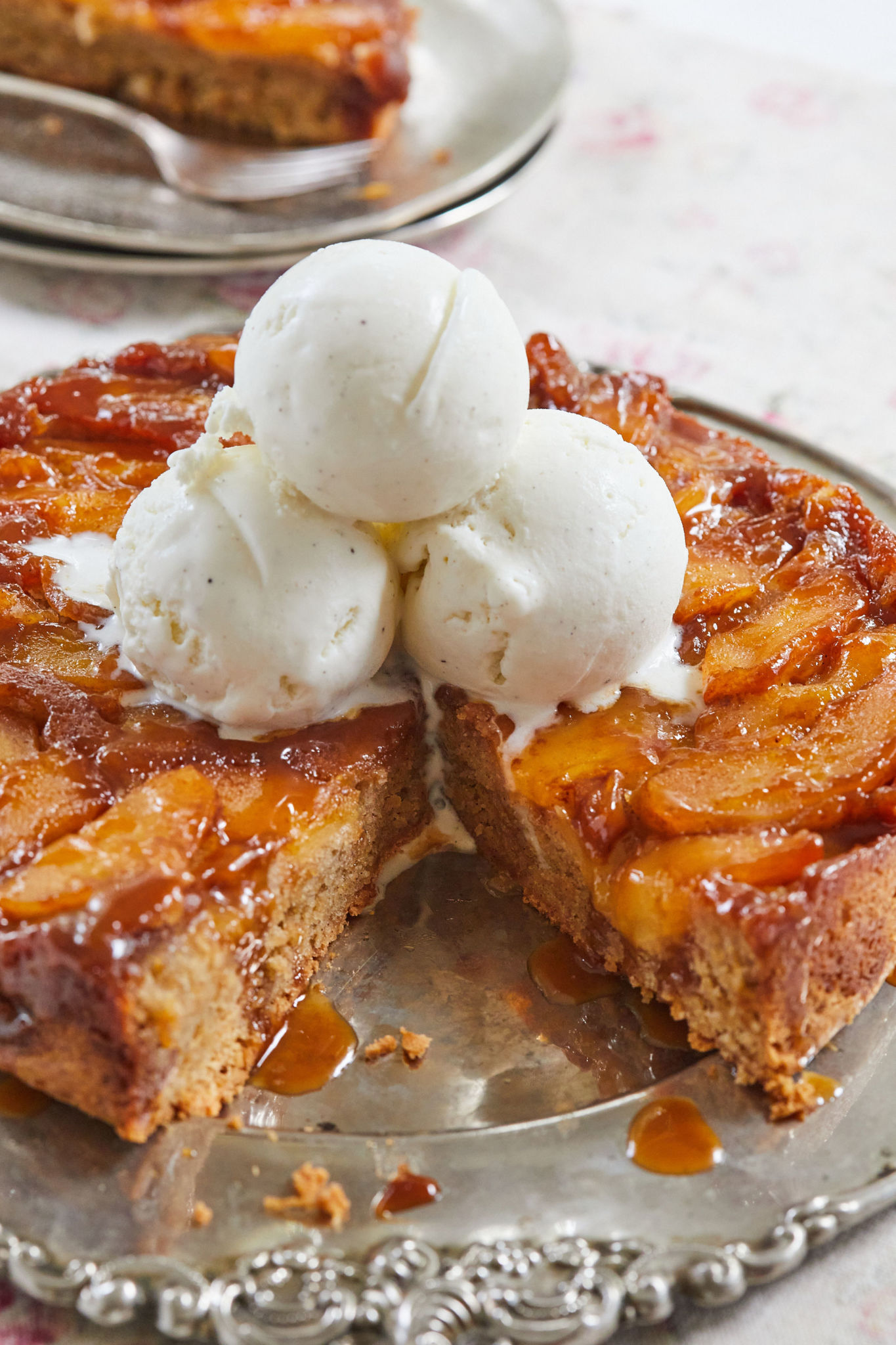 Caramel Apple Upside Down Cake with three scoops of ice cream on top.