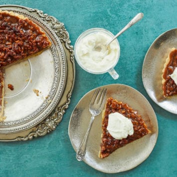 Two slices of my Walnut Caramel Tart next to the whole tart.