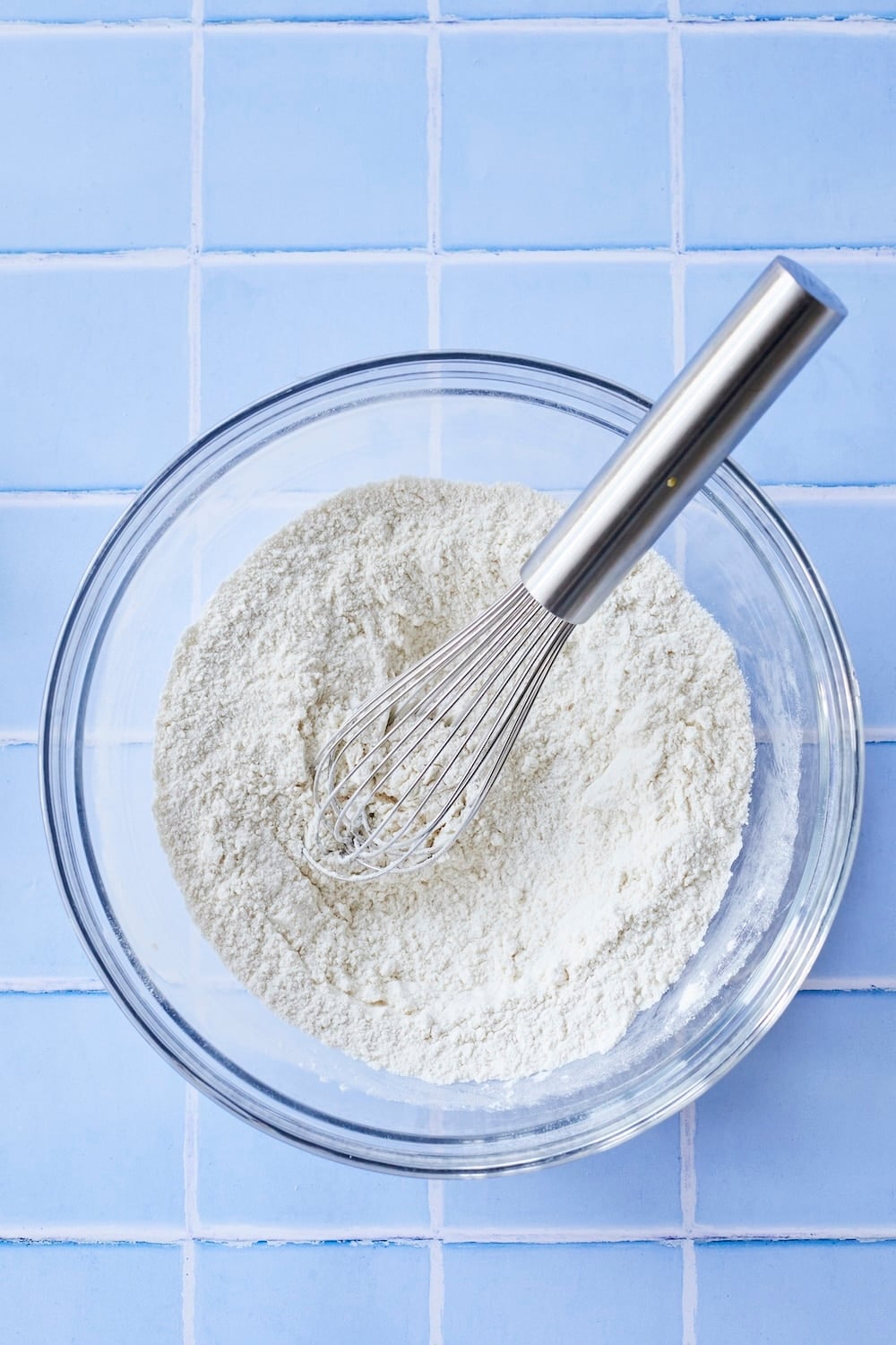 Dry ingredients mixed in a glass bowl. 