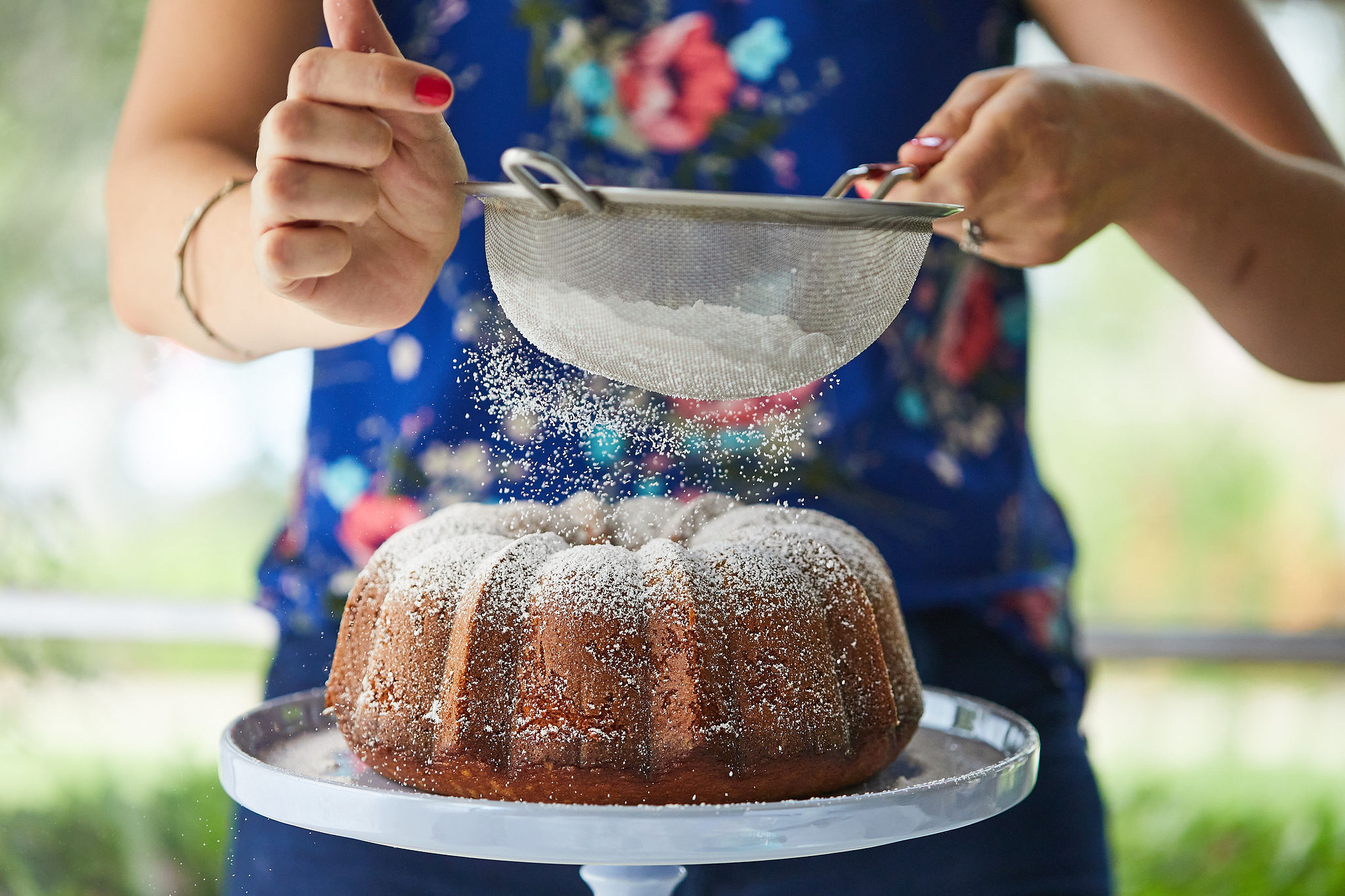 Olive Oil Cake being dusted with powdered sugar!