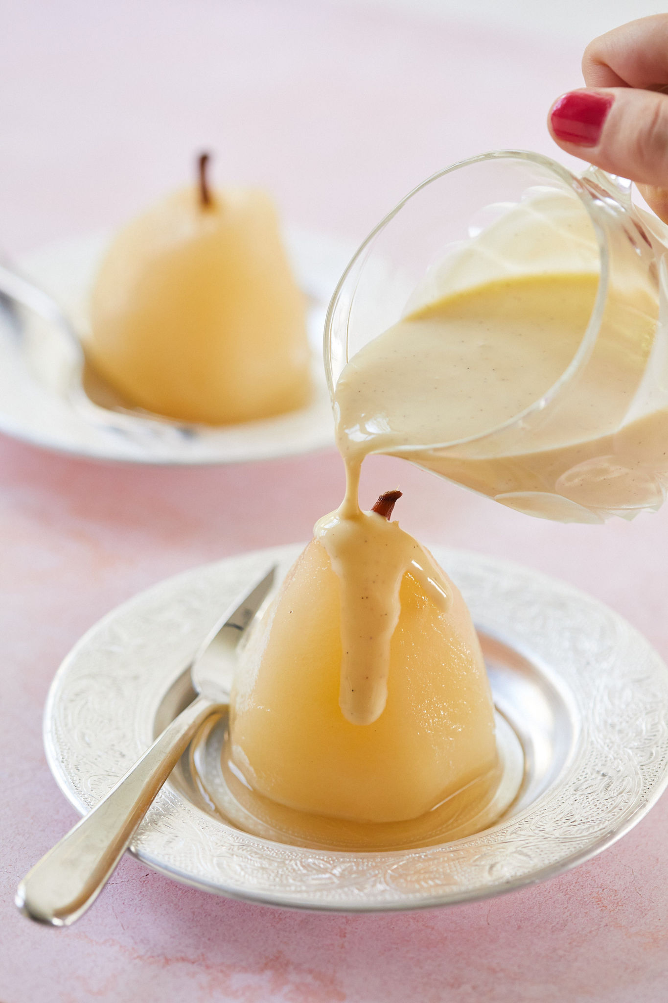 Poached Pears with creme anglaise poured on top.