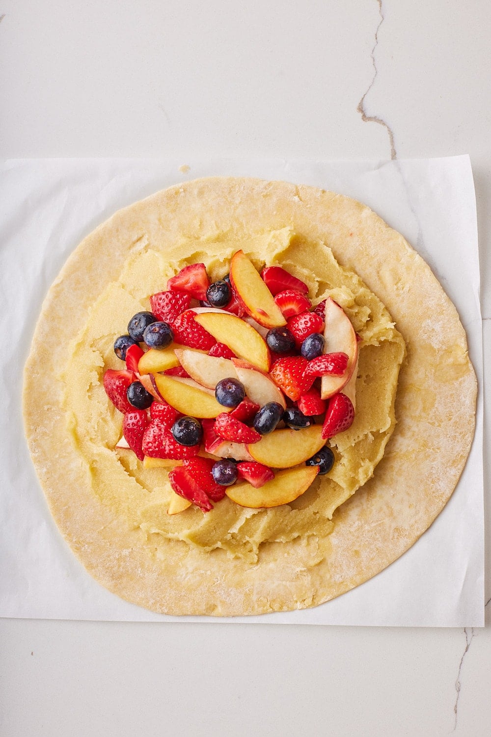 Rustic Fruit Galette4 Arrange the sliced fruit evenly on top of the frangipane.