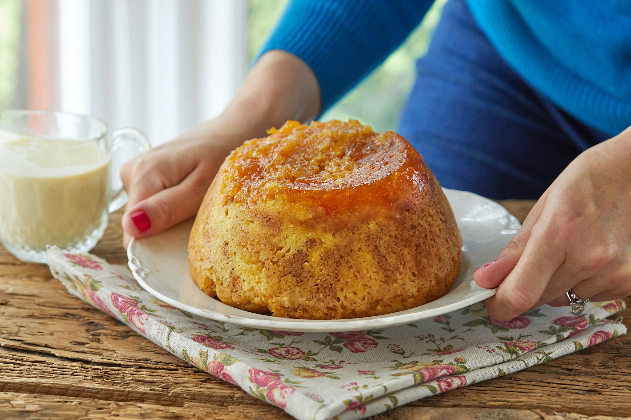 Placing a steamed marmalade pudding onto the table.