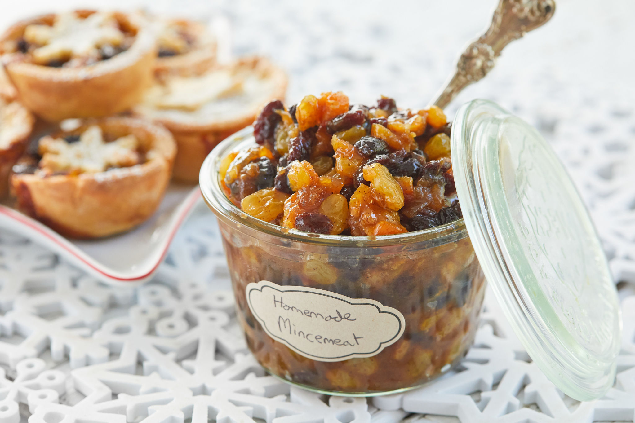 A jar of mincemeat with a spoon in it.