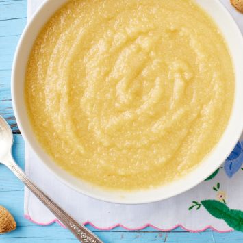 Frangipane in a bowl with almonds around it.