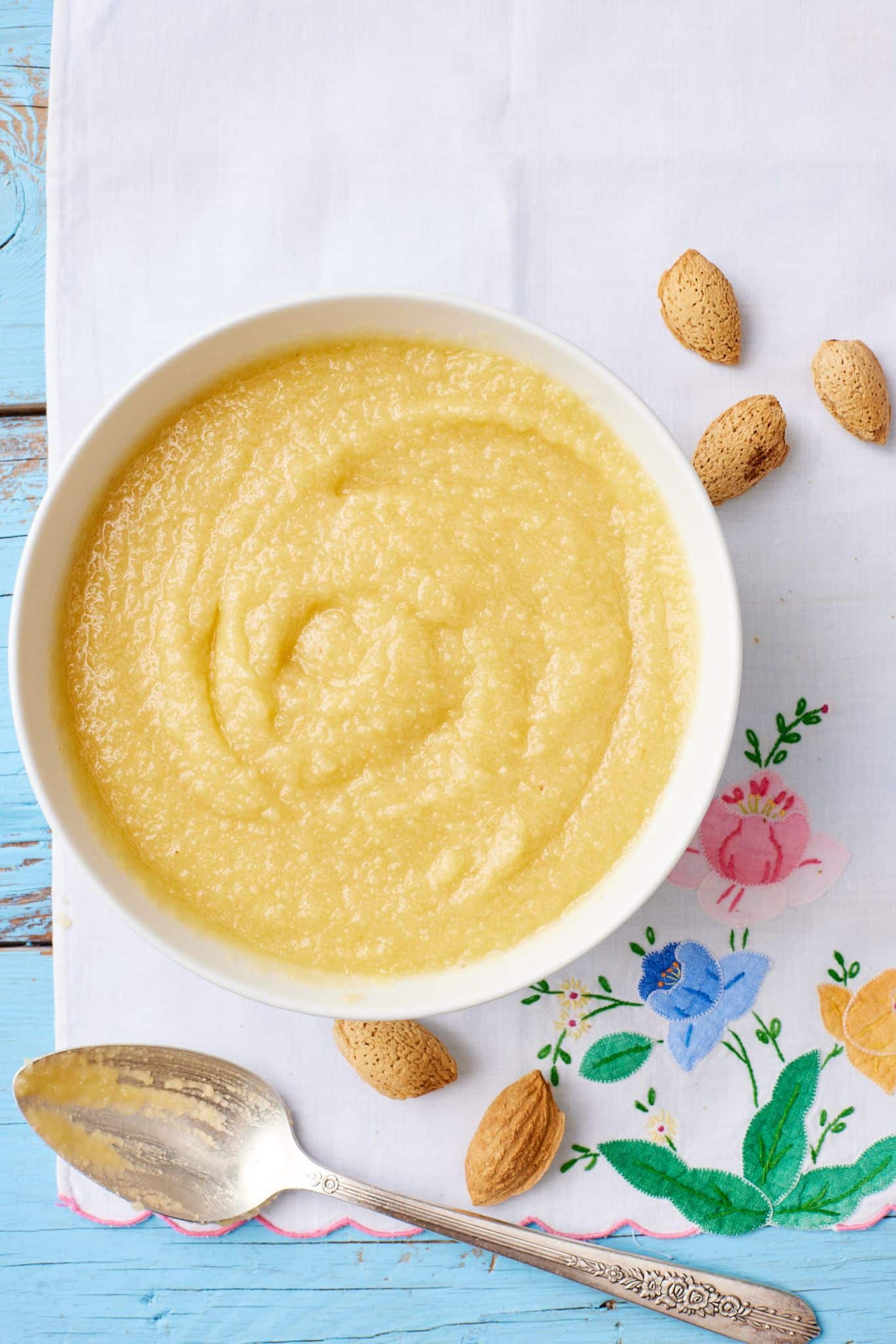 A bowl of homemade frangipane with almonds on the side. 