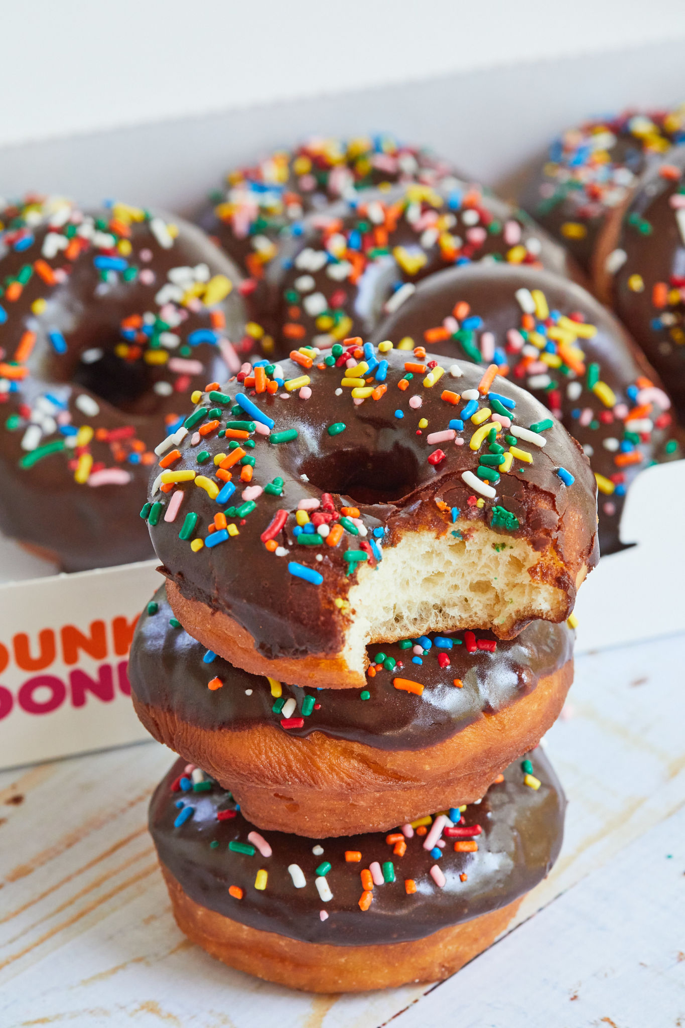 A stack of homemade chocolate glazed Dunkin Donuts.