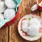 Pfeffernüsse cookies next to a tin of cookies.