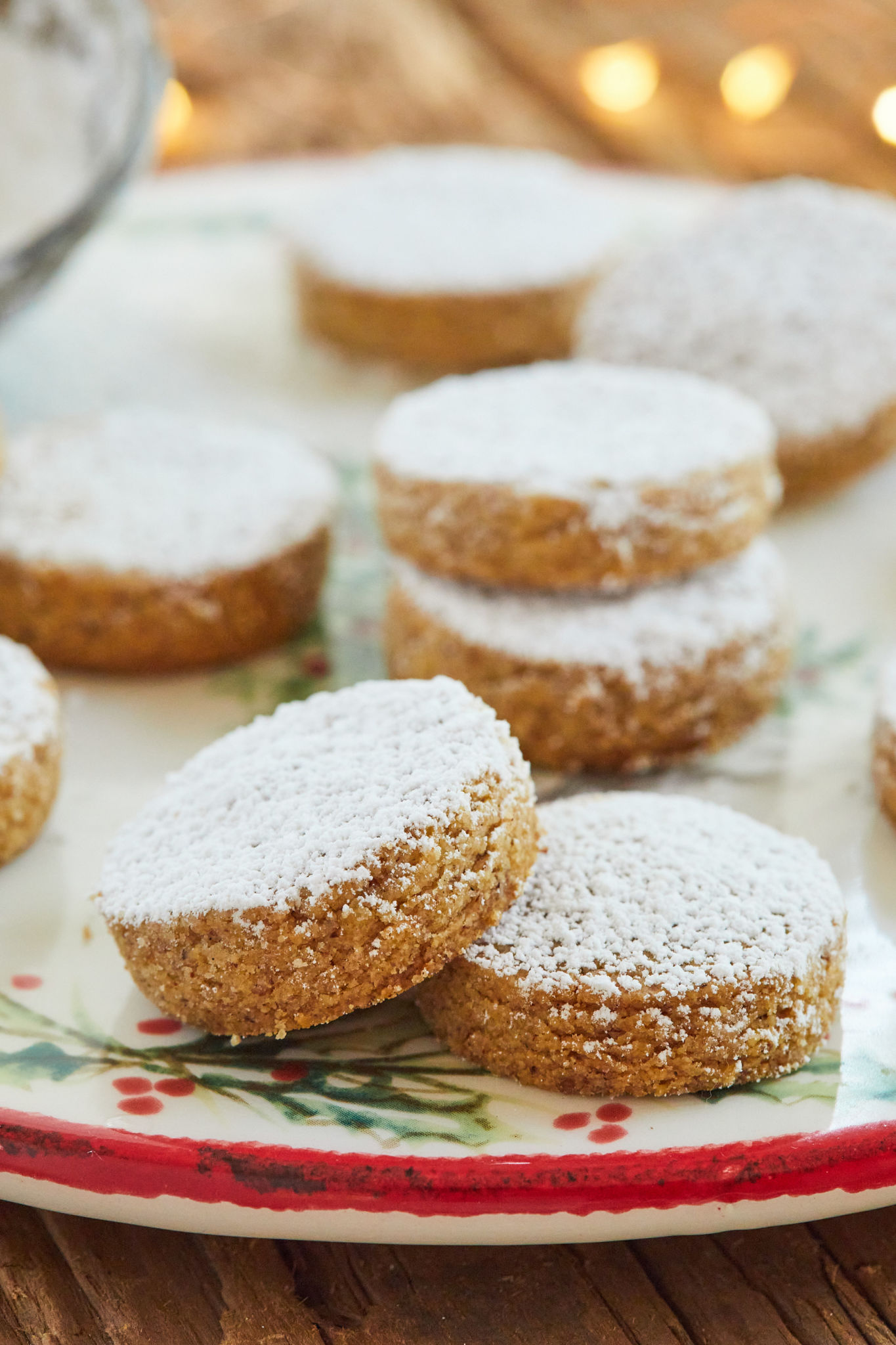 A plate of Spanish Almond Cookies dusted with powdered sugar.