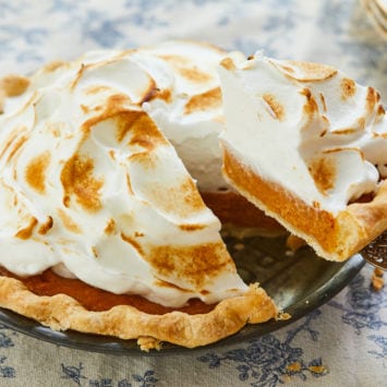 Lifting a slice of sweet potato pie.