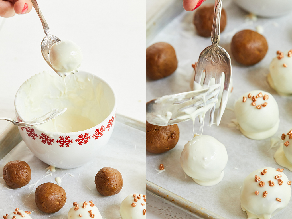 Dipping Gingerbread Truffles with a fork in white chocolate.