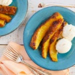 Three slices of pineapple, roasted and served with ice cream.