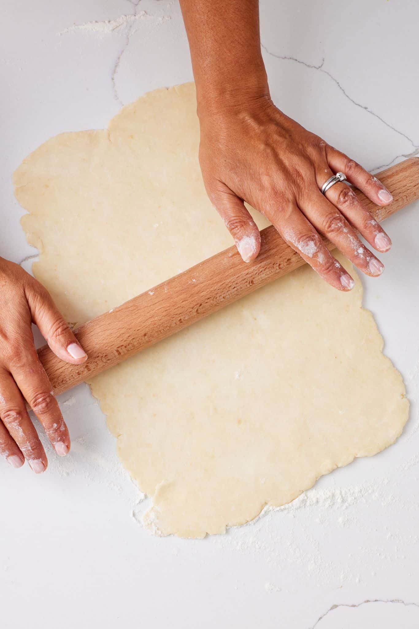 Rolling out the Rugelach dough with a rolling pin. 