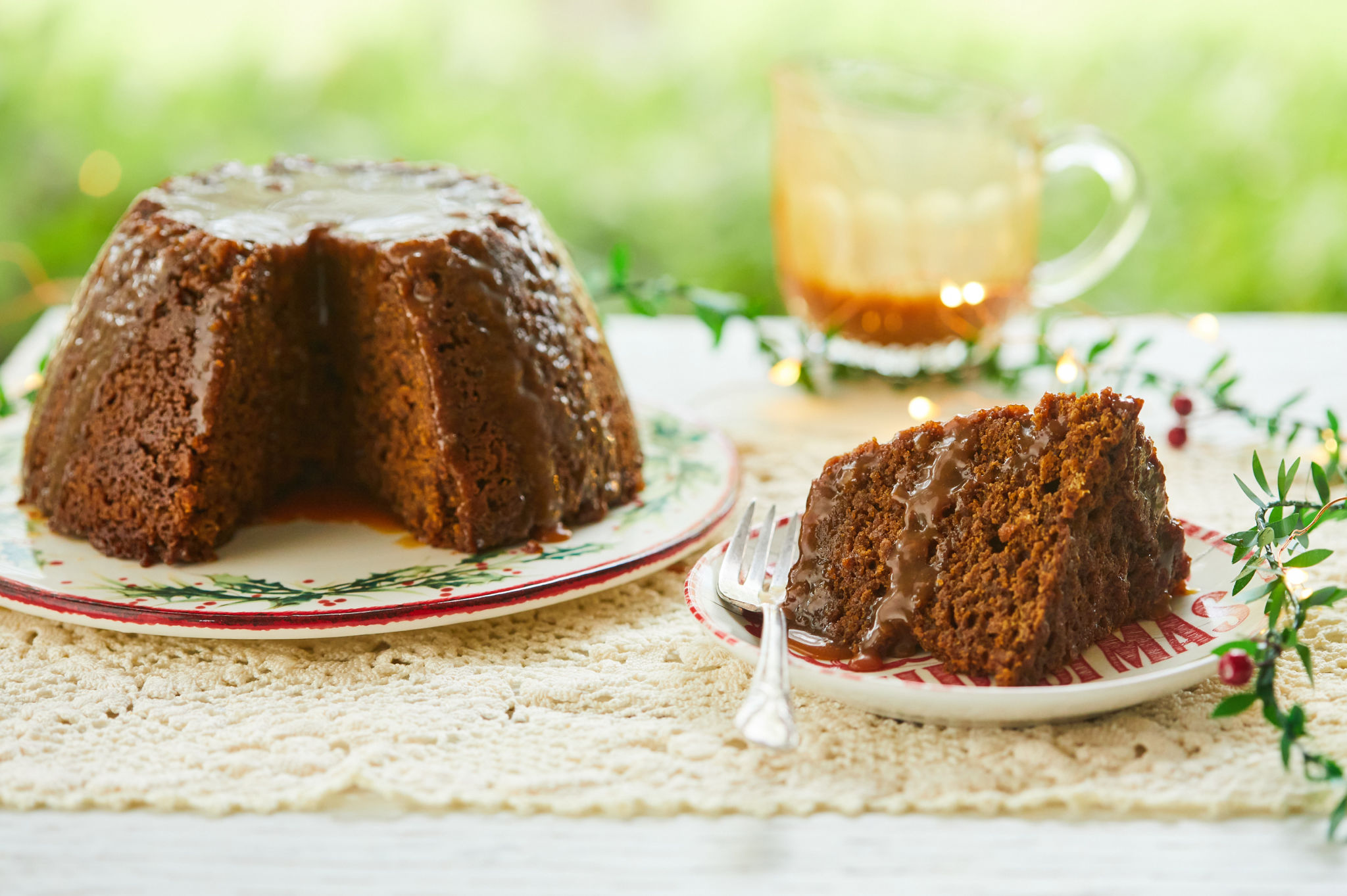 An entire gingerbread pudding next to a slice.
