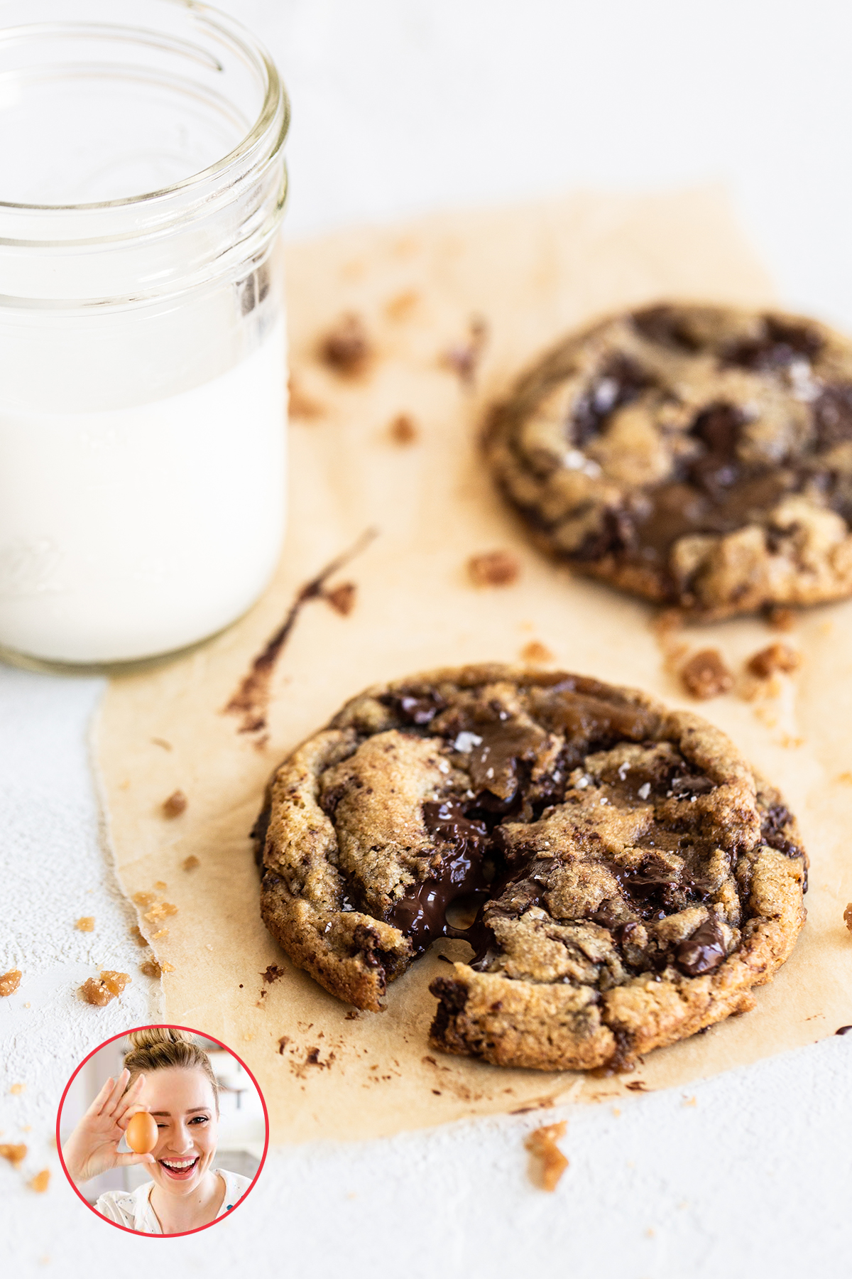Gooey Toffee Chocolate Chip Cookies next to a glass of milk.