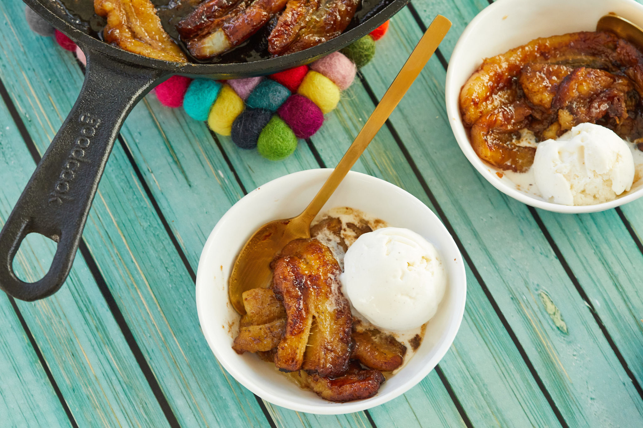 My bananas foster recipe served into two bowls with vanilla ice cream.