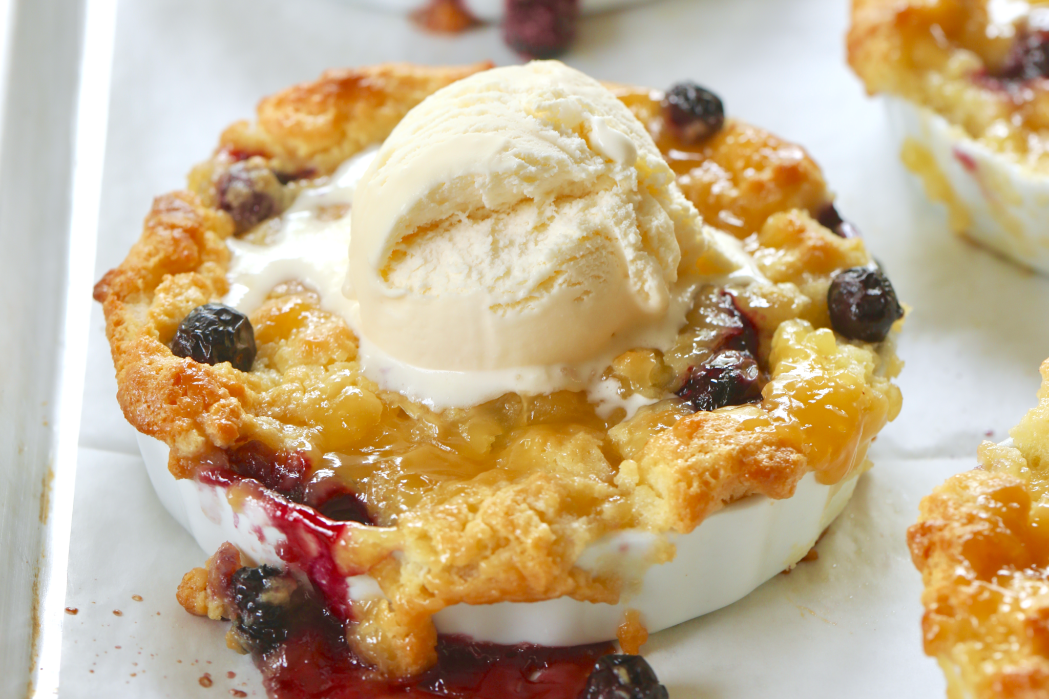 Blueberry & Lemon Curd Bread Pudding topped with vanilla ice cream