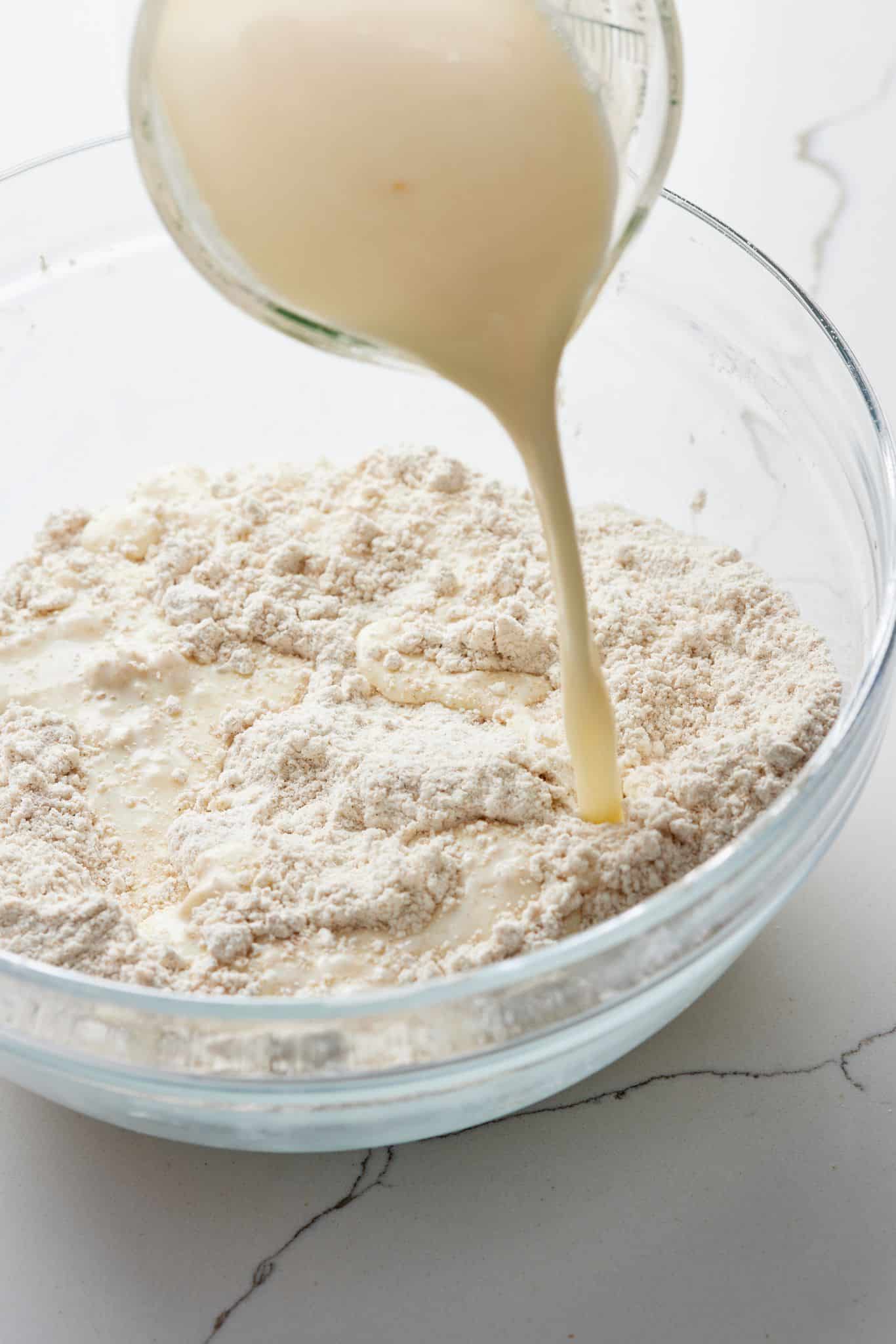 Pour wet ingredients mixture into dry ingredients mixture of Irish Brown Soda Bread.