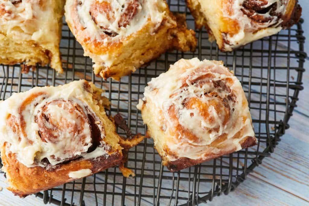 No-Knead Cinnamon Rolls resting on a cooling rack.