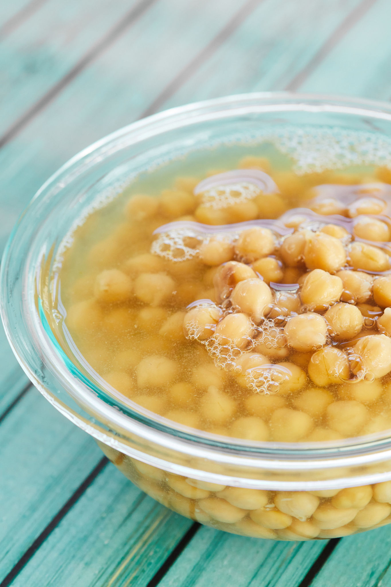 A bowl of chickpeas sitting in aquafaba.