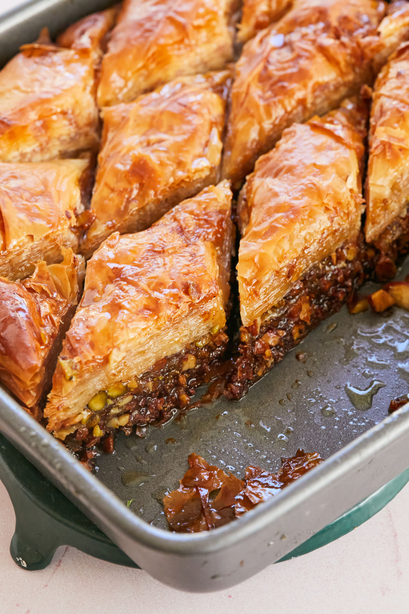A pan of baklava with servings removed.