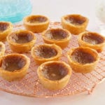 Tiny Canadian Butter Tarts on a cooling rack.
