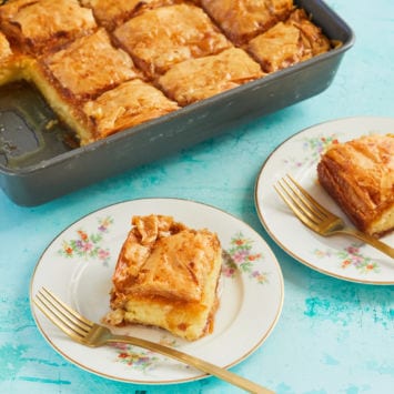 Slices of Galaktoboureko on dishes.