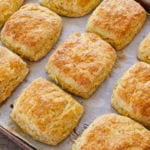 Baked Sage & Cheddar Biscuits arranged on a baking sheet.