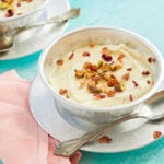A bowl of Shrikhand topped with nuts.
