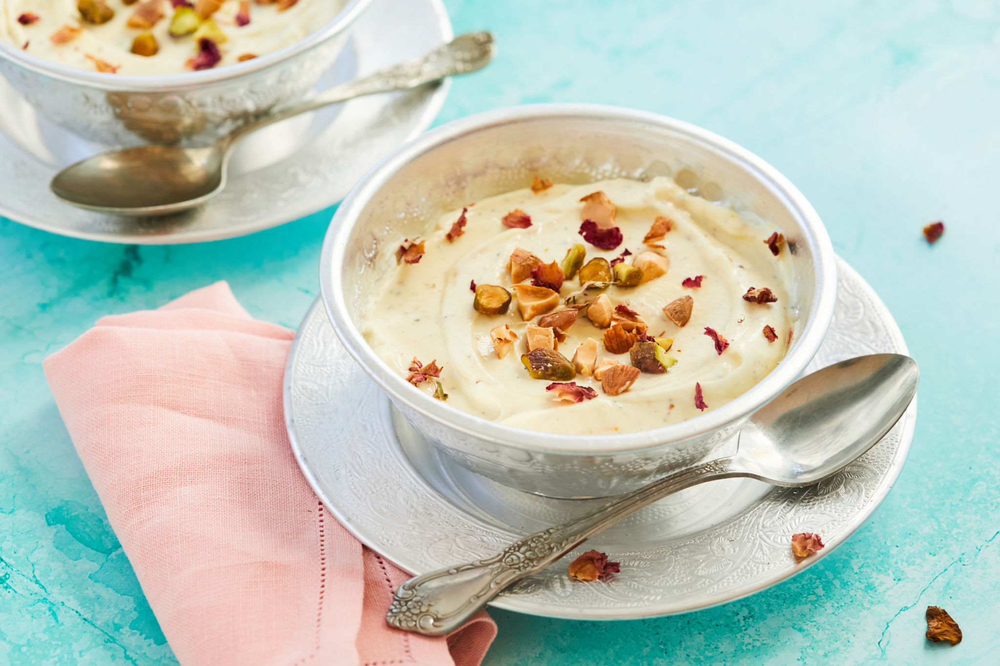 A bowl of Shrikhand topped with nuts.