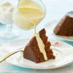 Steamed Carrot Cake Pudding being drizzled with creme anglaise.