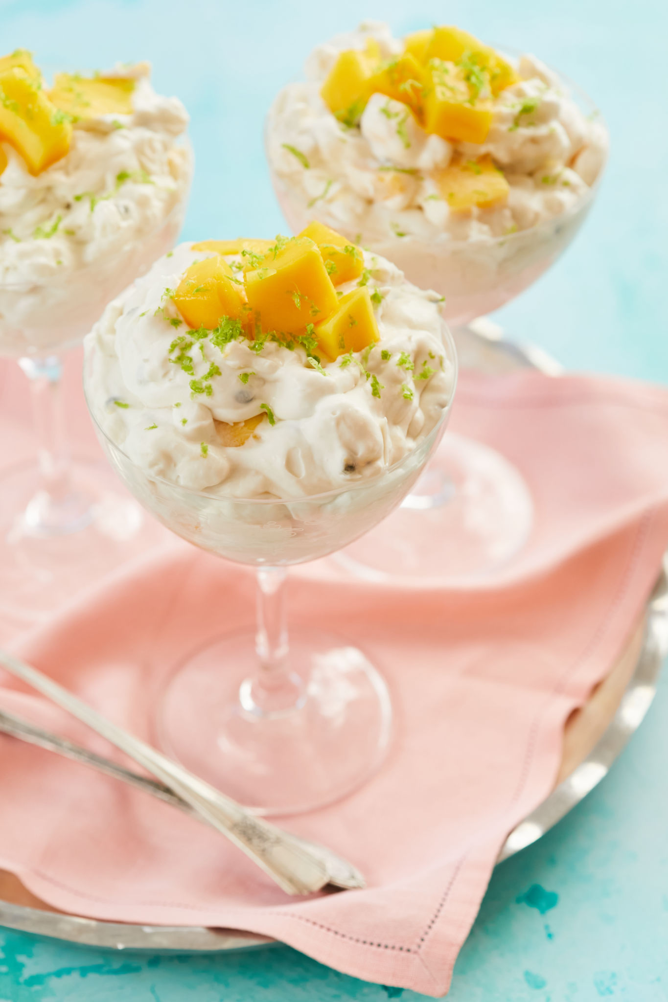 A dish of tropical Eton mess in a wine glass.