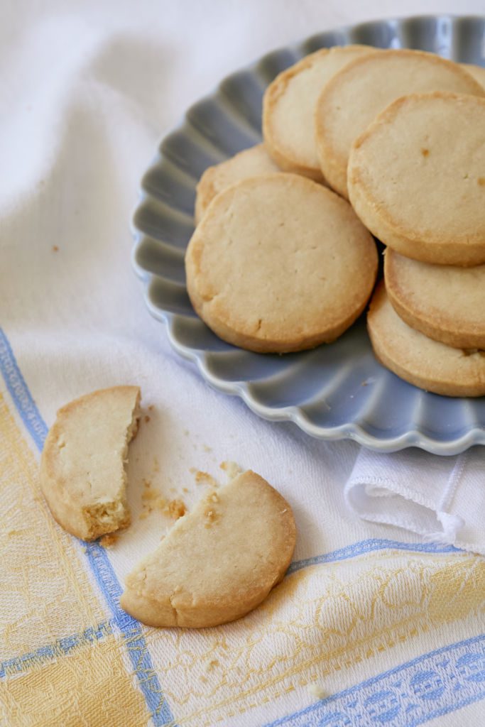 Buttery, crumbly Shortbread cookies are served on a blue dessert plate.