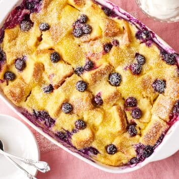 Top down view of a baking dish of golden lemon blueberry bread pudding.