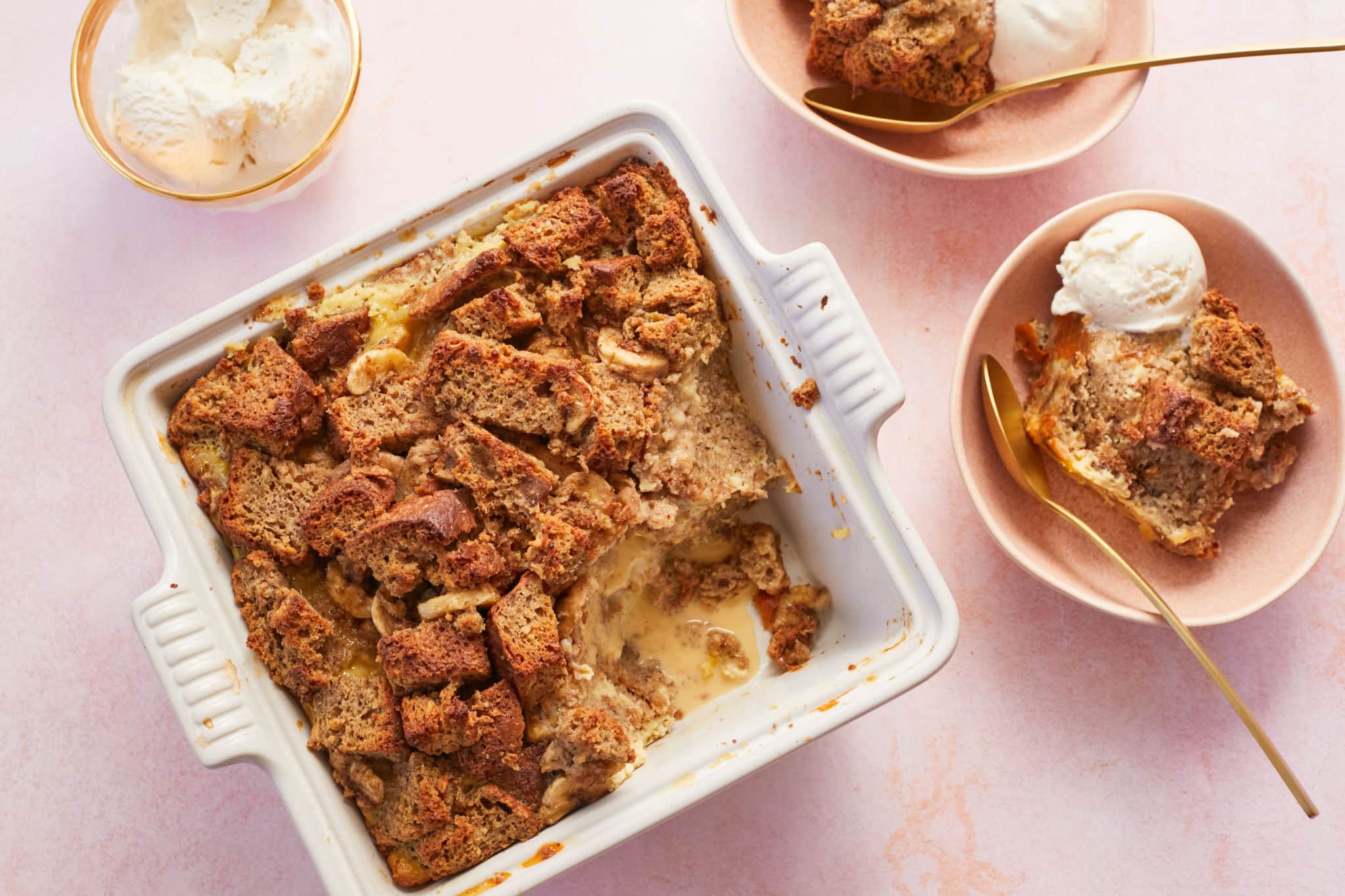 Banana Bread Pudding in a serving dish with two bowls.