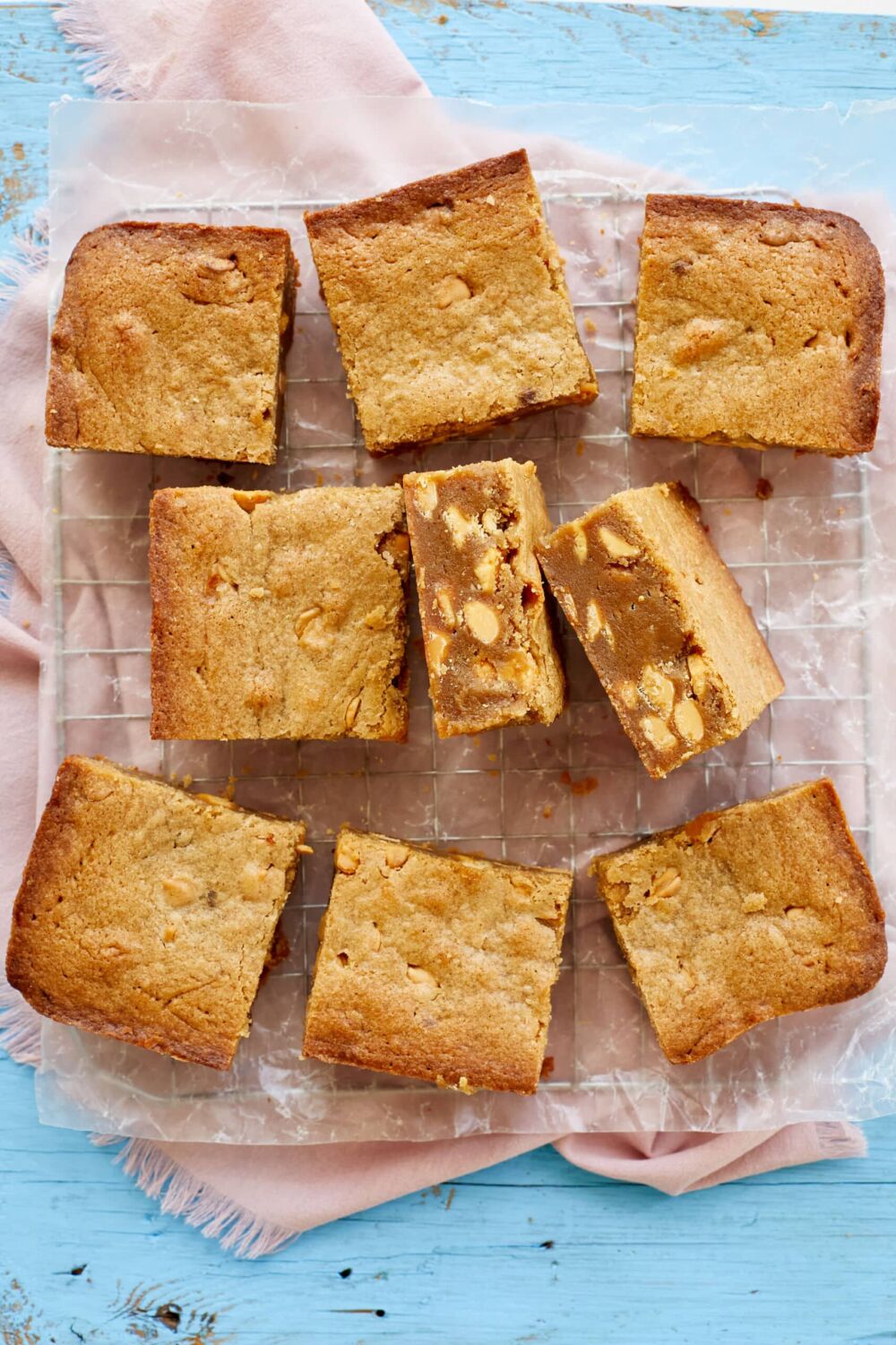 Best Ever Blondies7 an overhead view on Best-Ever Blondies with sunny topping. Two squares show the white chocolate chips.