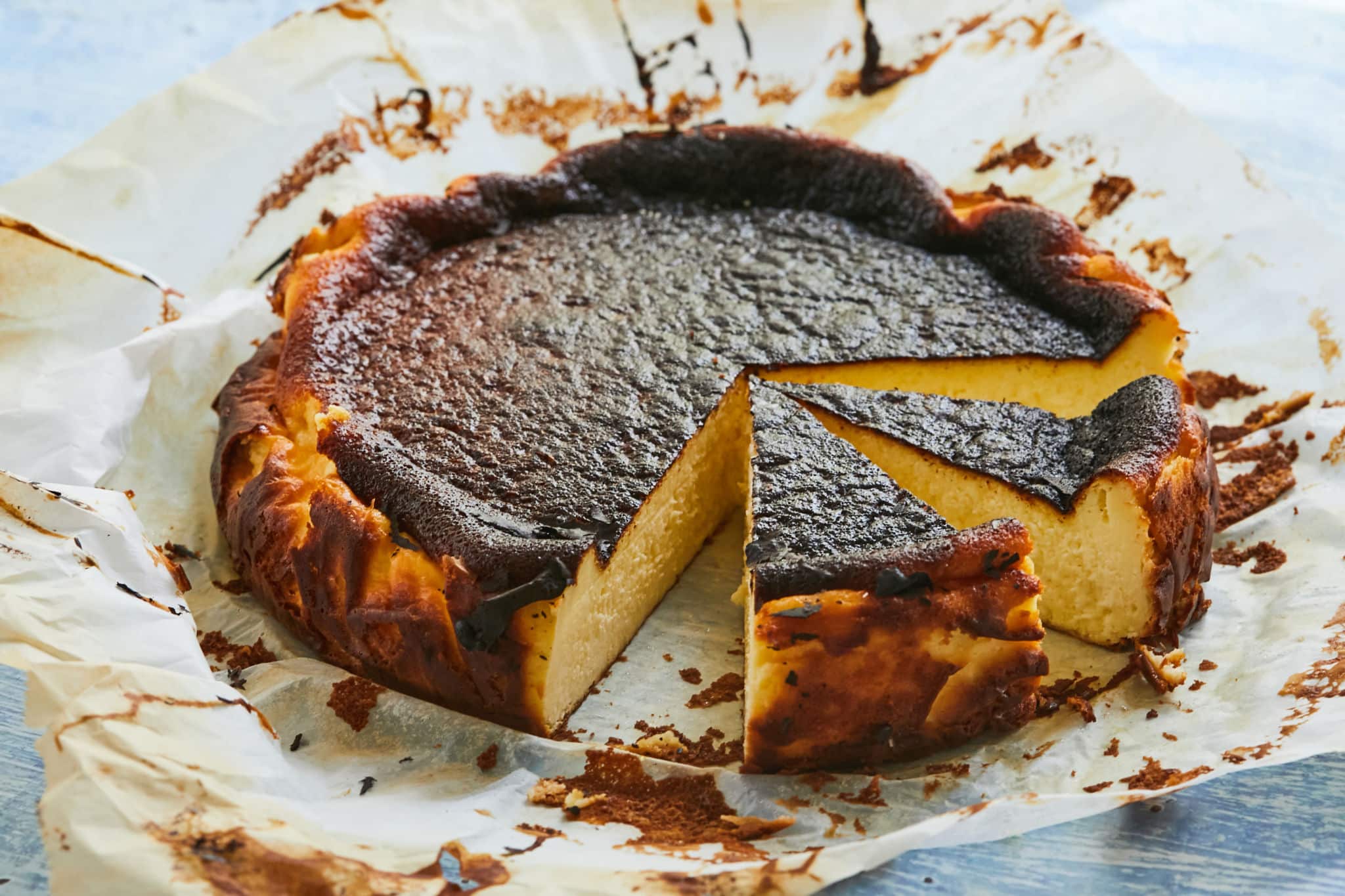 A burnt basque cheesecake with two slices.